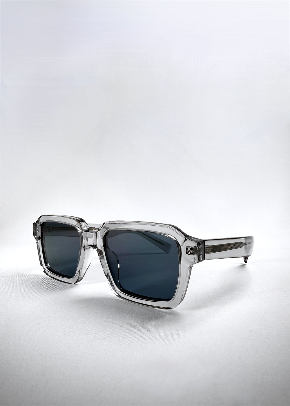 Angled right-side view of Crest - Glacier sunglasses, revealing the clean silhouette and frosted crystal acetate finish.