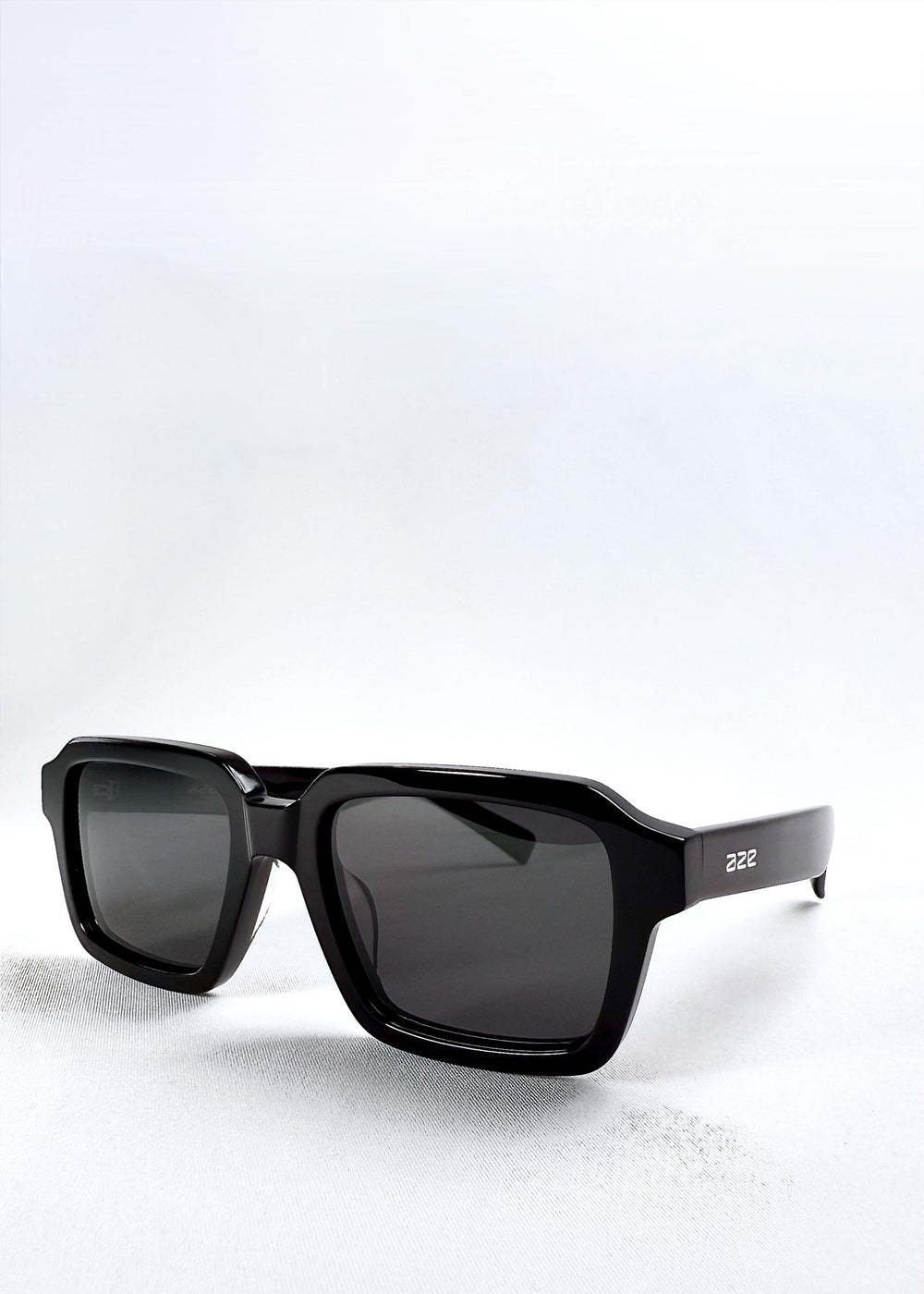 Angled product view of Crest - Obsidian Black sunglasses highlighting the thick acetate frame and clean squared lens design. #color_obsidian-black