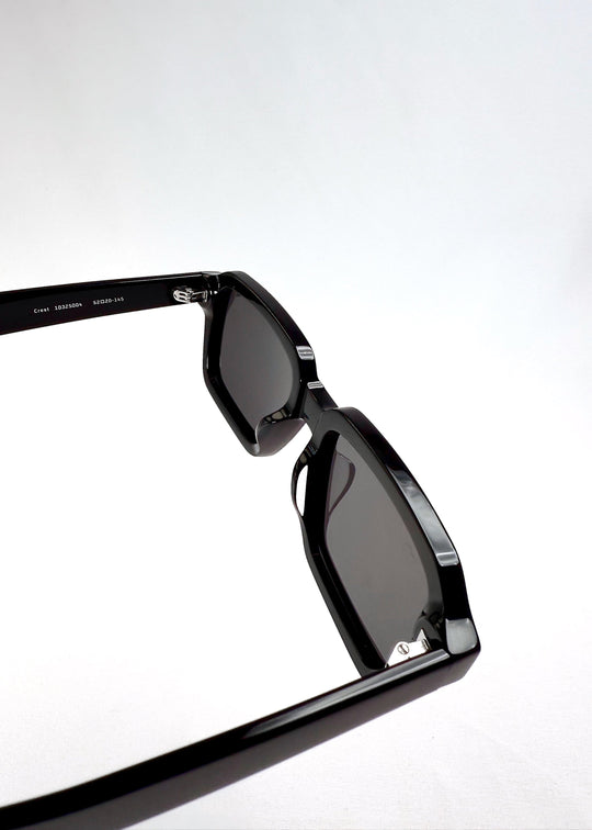 Macro detail of the hinge area on Crest - Obsidian Black sunglasses showing durable construction and precision engineering. 