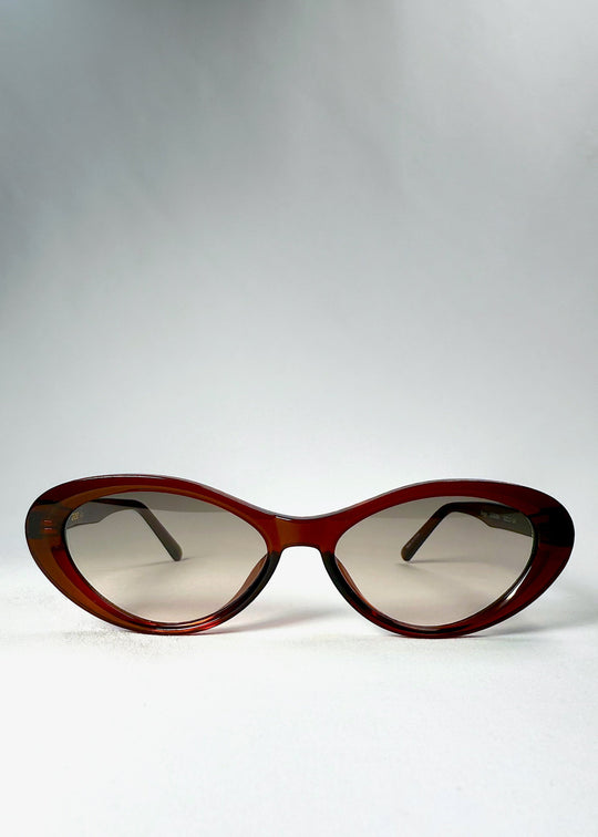 Front view of Dagger sunglasses in Crimson Mist showing the dark red cat-eye frame and lightly tinted lenses. 