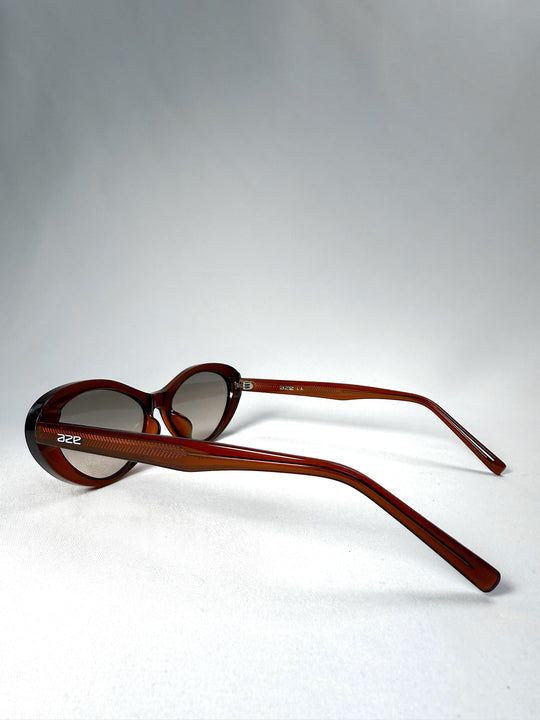 Side view of Dagger sunglasses in Crimson Mist showing the extended temples and frame profile. 