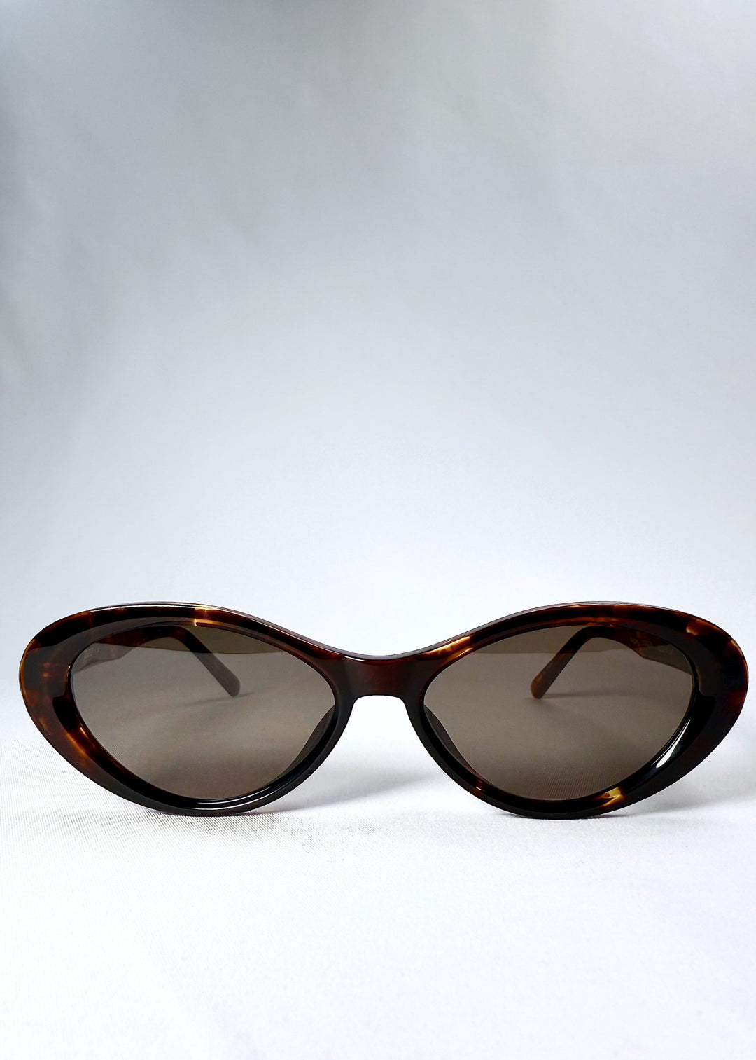 Front view of Dagger in Ember Fade sunglasses showcasing the cat-eye silhouette and tortoiseshell frame. 