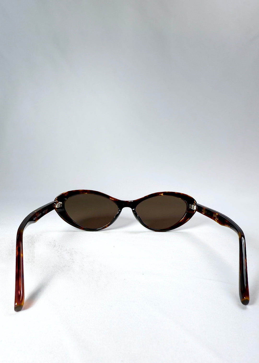 Inside view of the Dagger in Ember Fade sunglasses, showing the interior hinge and frame details. 