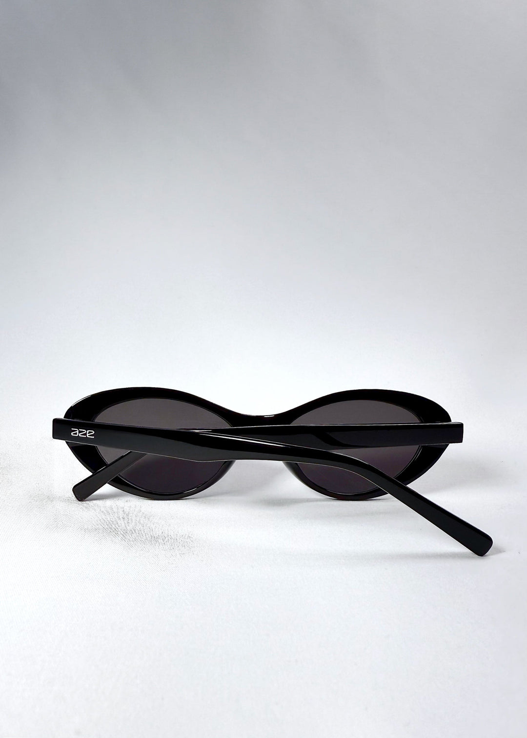 Folded view of Dagger in Obsidian Black showing compact frame and glossy black temple details. 