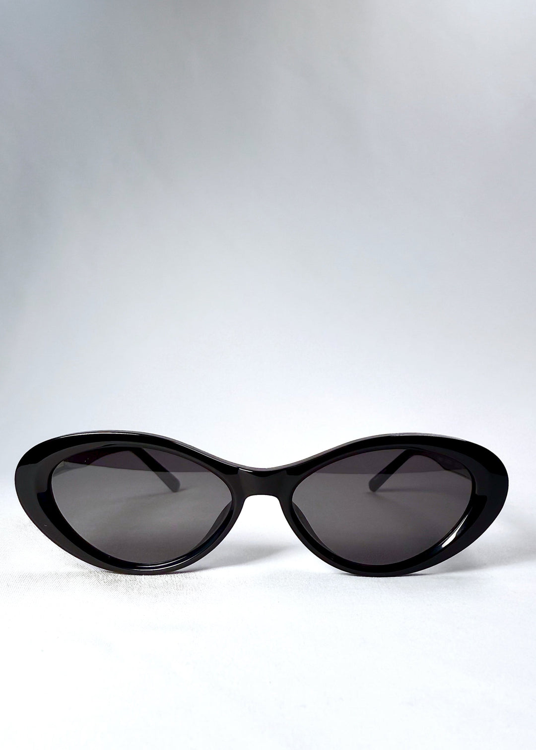 Front view of Dagger sunglasses in Obsidian Black showing full cat-eye silhouette and dark nylon lenses.