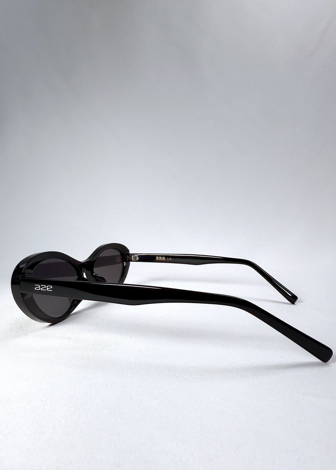 Side view of Dagger sunglasses in Obsidian Black showing the sculpted acetate temples and AZE logo. 