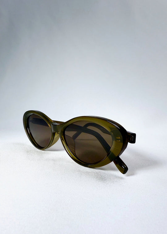 Folded view of Dagger sunglasses in Olive Shadow highlighting the compact shape and hinge flexibility. 