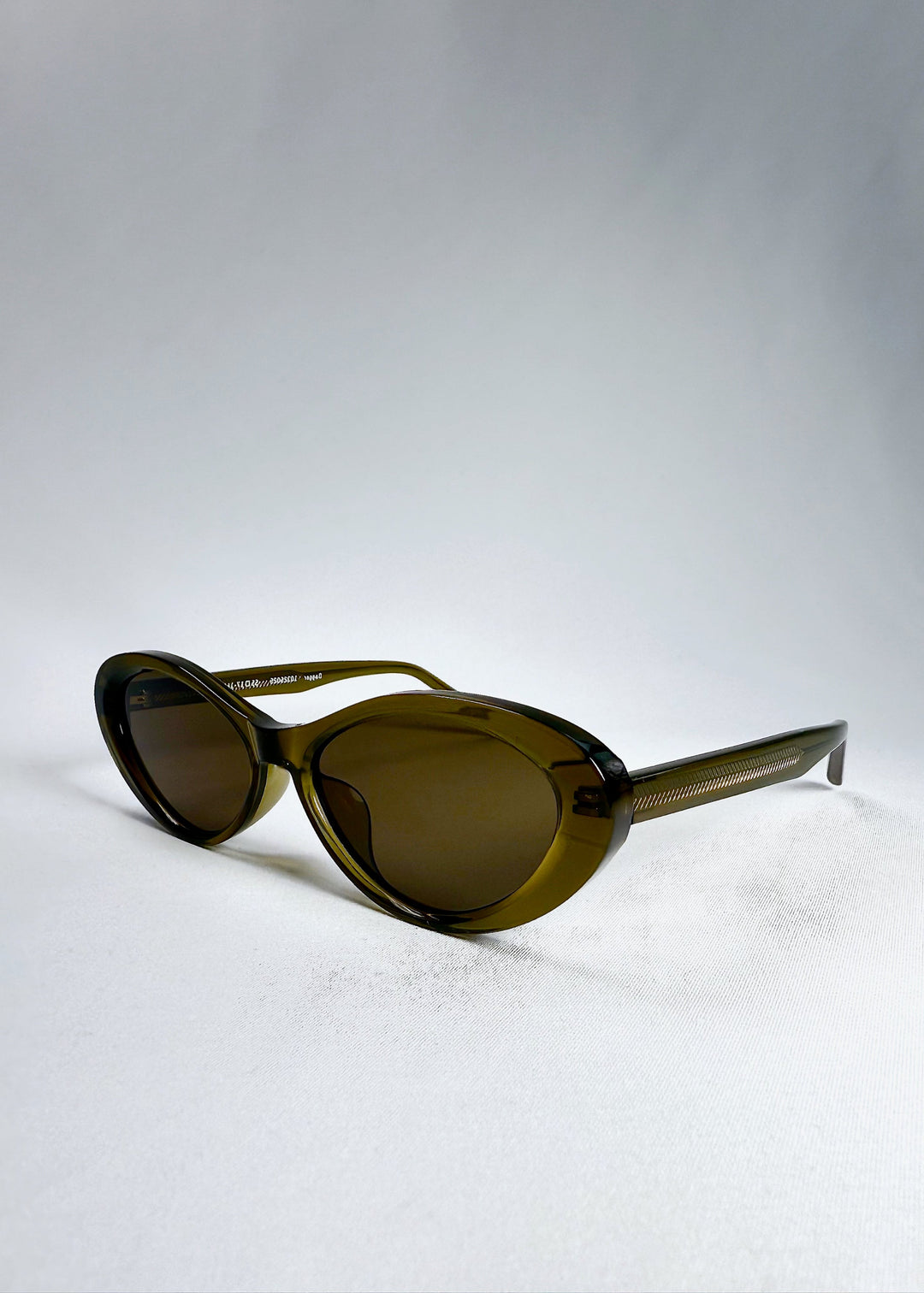 Angled front view of Dagger in Olive Shadow showing the sleek contours and glossy finish of the acetate frame. 