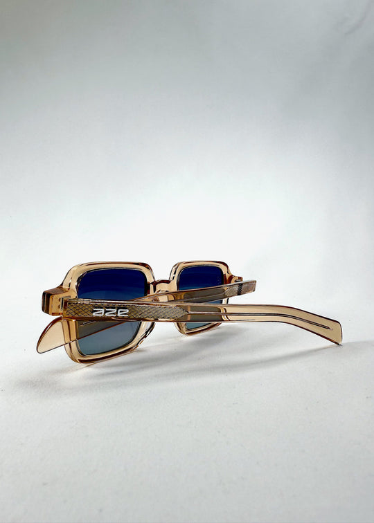 Folded side view of Draxen - Amber Frost frame showing gradient lenses and embossed temple detail. 