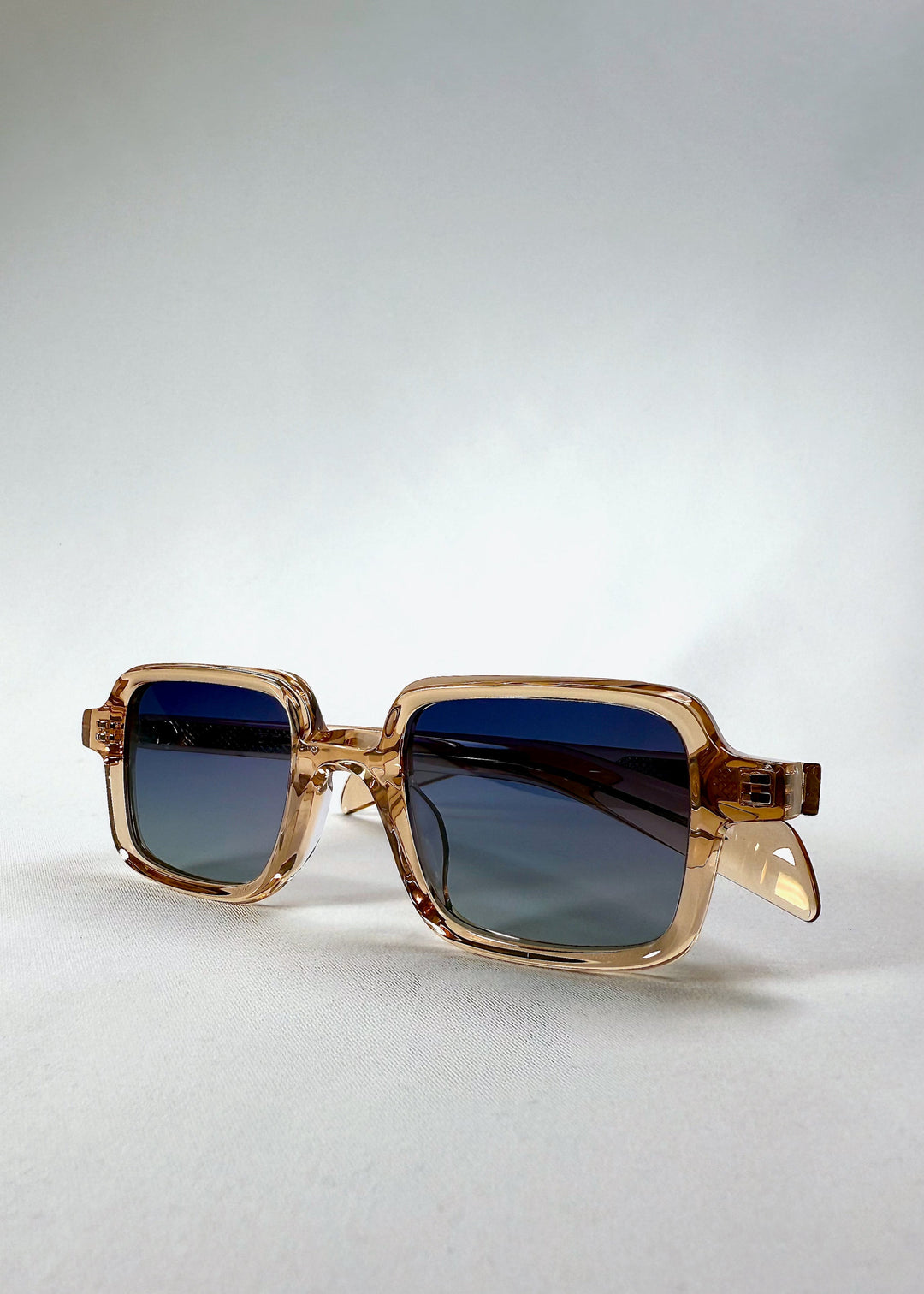 Draxen - Amber Frost in angled display, showing subtle frame thickness and lens gradient color. 