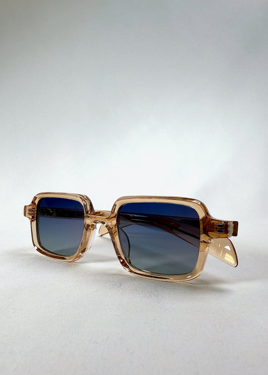 Draxen - Amber Frost in angled display, showing subtle frame thickness and lens gradient color. 