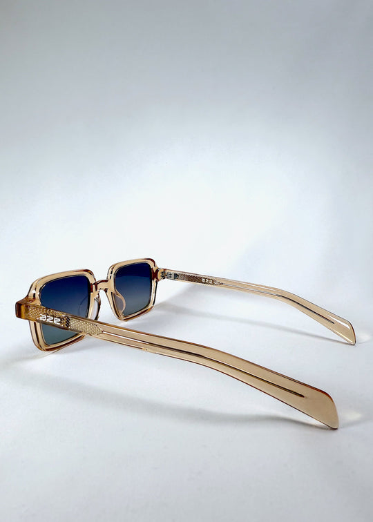 Side view of Draxen - Amber Frost sunglasses showing slim curved temple and metallic accent pattern. 