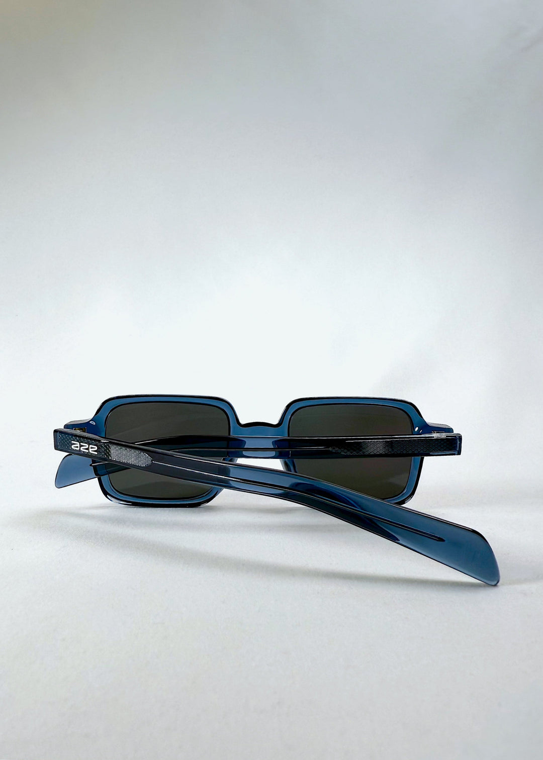 Folded view of Draxen in Glacial Blue, displaying both temples and the lightweight construction. 