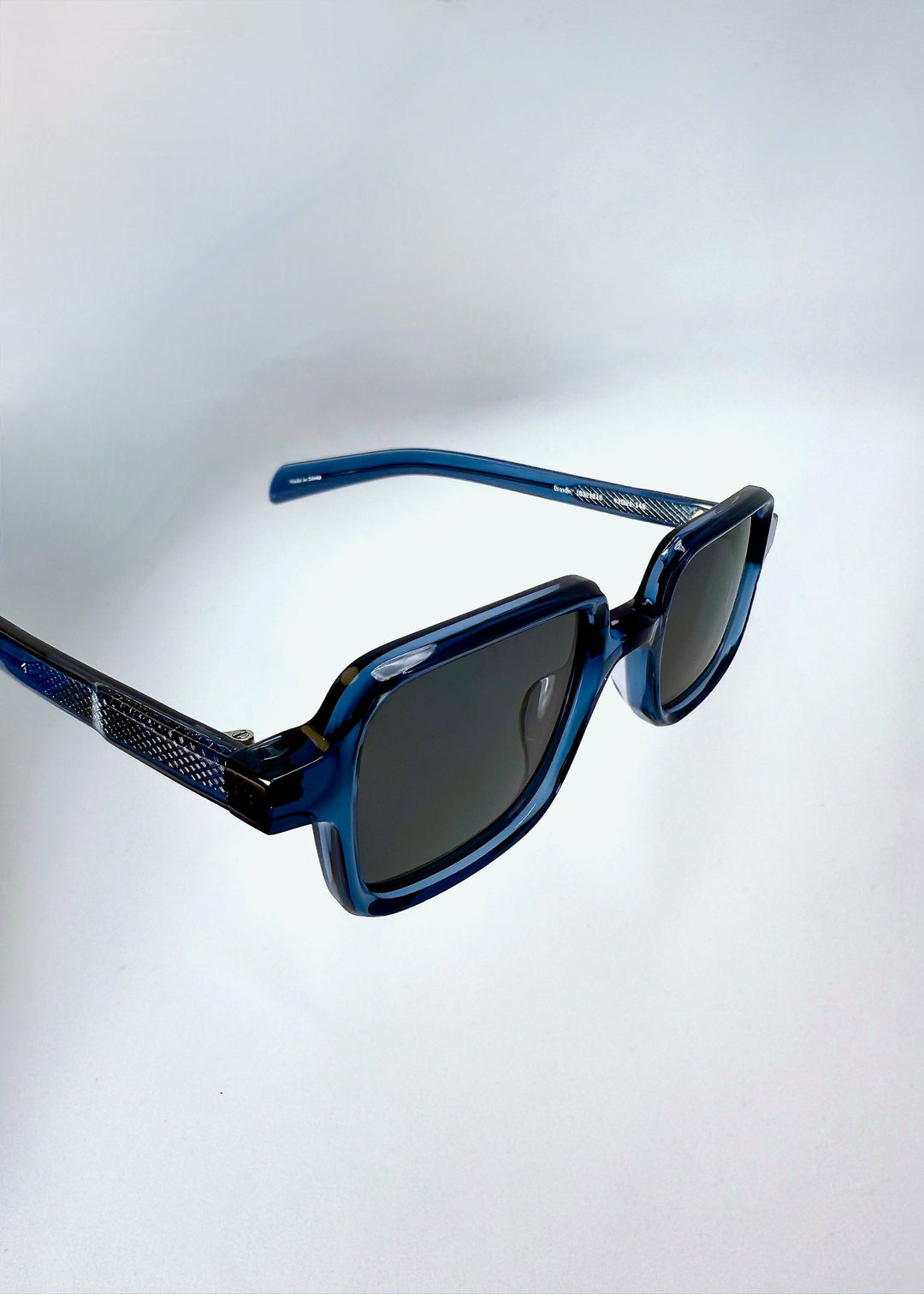 Closeup of the front angle of Draxen in Glacial Blue, emphasizing the translucent frame and lens detail. 