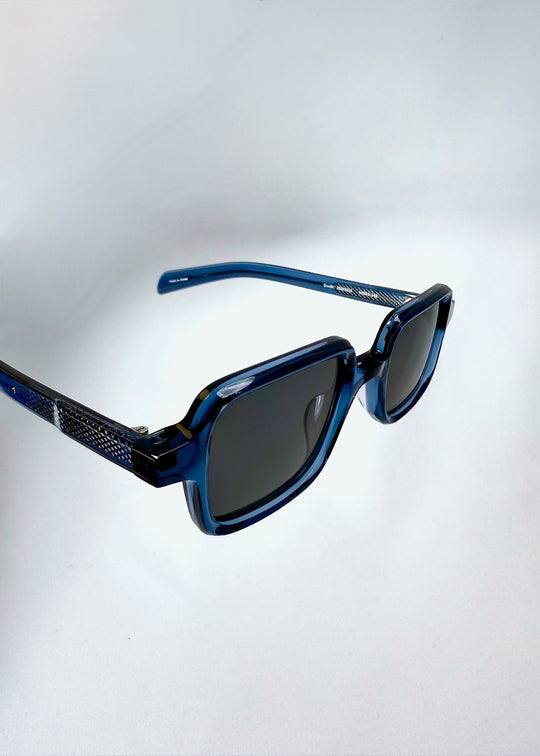 Closeup of the front angle of Draxen in Glacial Blue, emphasizing the translucent frame and lens detail. 
