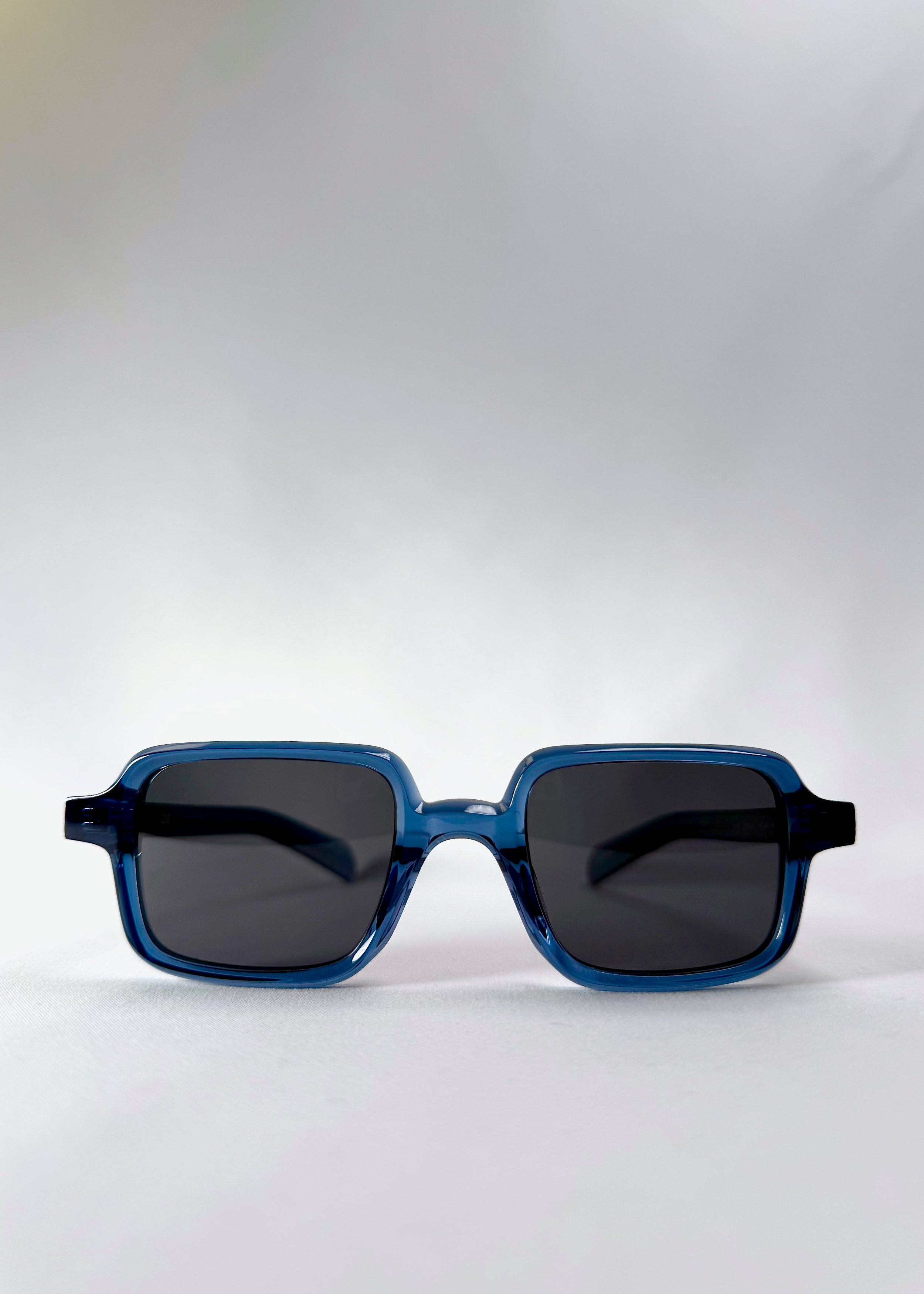 Front view of Draxen in Glacial Blue, showcasing its rectangular silhouette and translucent blue acetate frame.