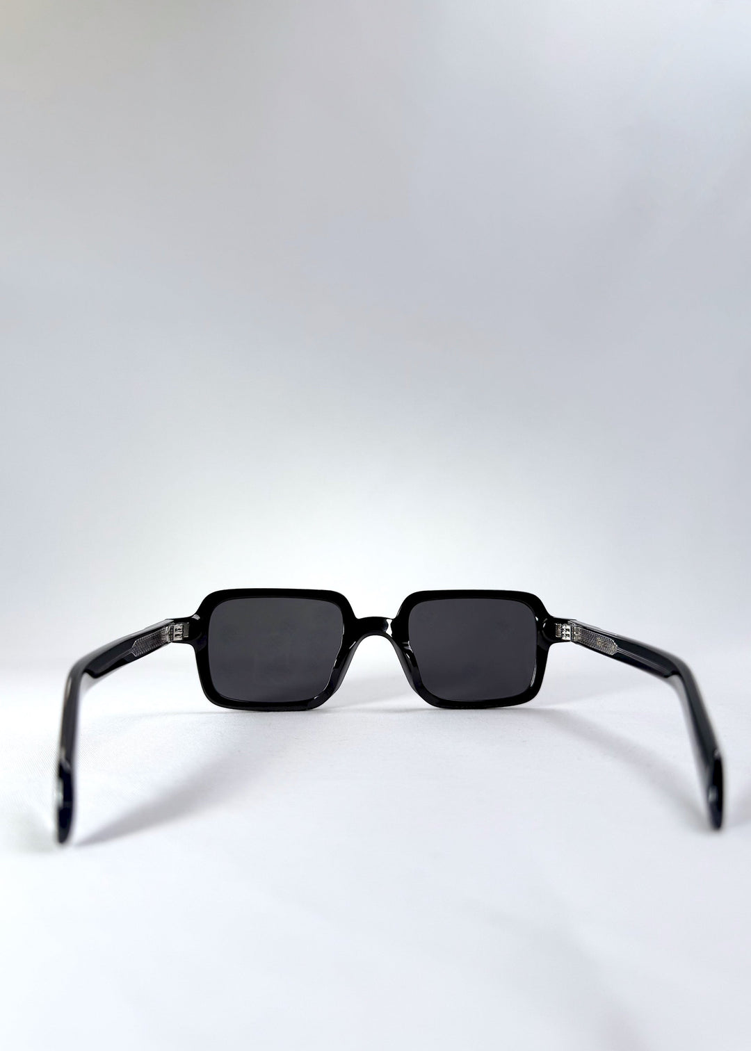 Back view of Draxen sunglasses in Obsidian Black highlighting the frame curvature and temple design. 