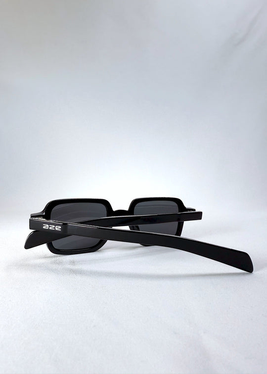 Folded side view of Draxen sunglasses in Obsidian Black with the AZE logo visible on the temples. 