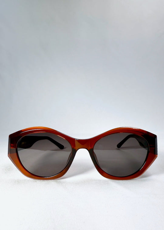 Front view of Eclipse Feline sunglasses in Burnished Umber with cat-eye silhouette and dark UV400 lenses. 