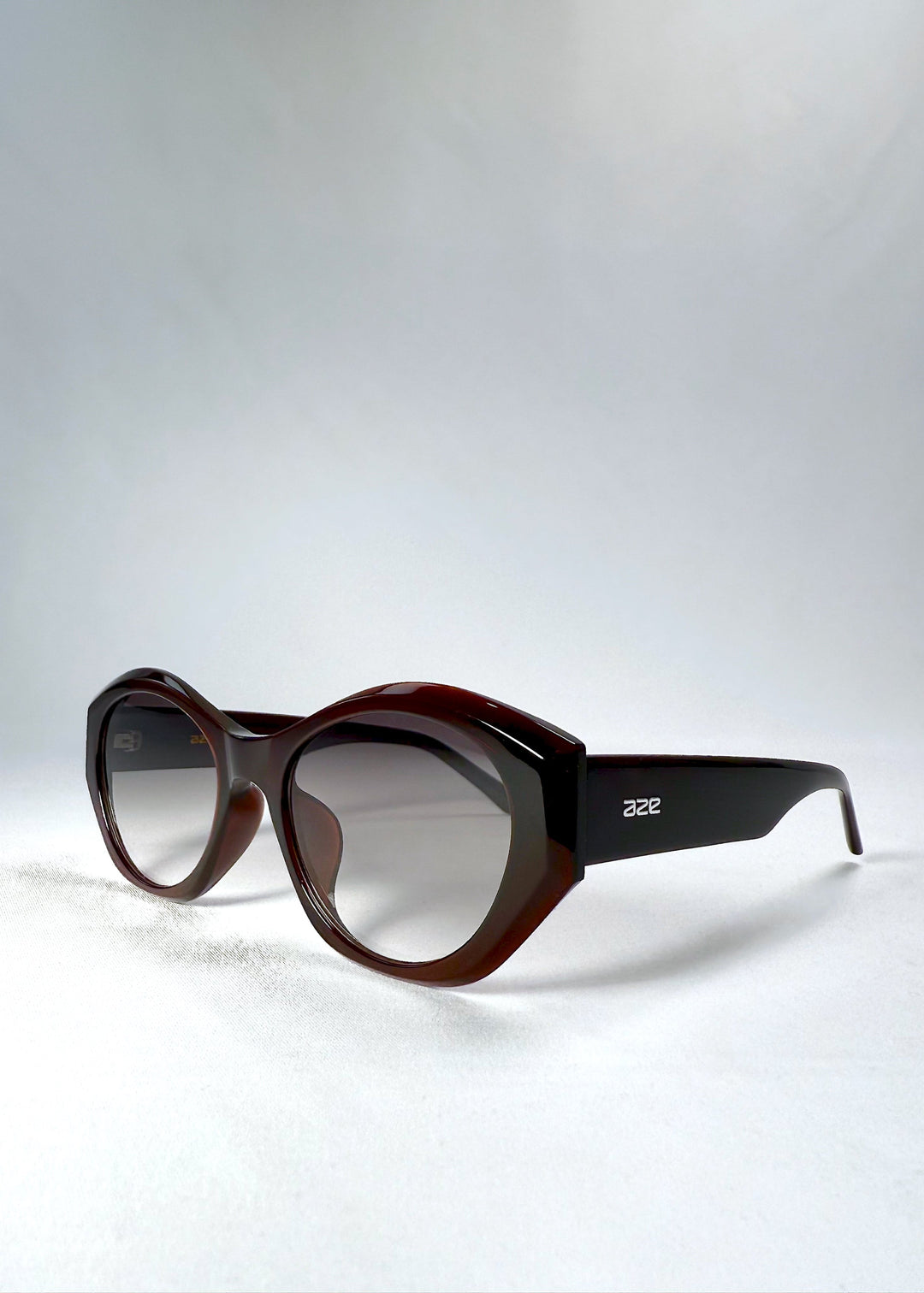 Eclipse Feline in Crimson Mirage shown from a front angle, highlighting its sculptural curves and bold cat-eye silhouette. 