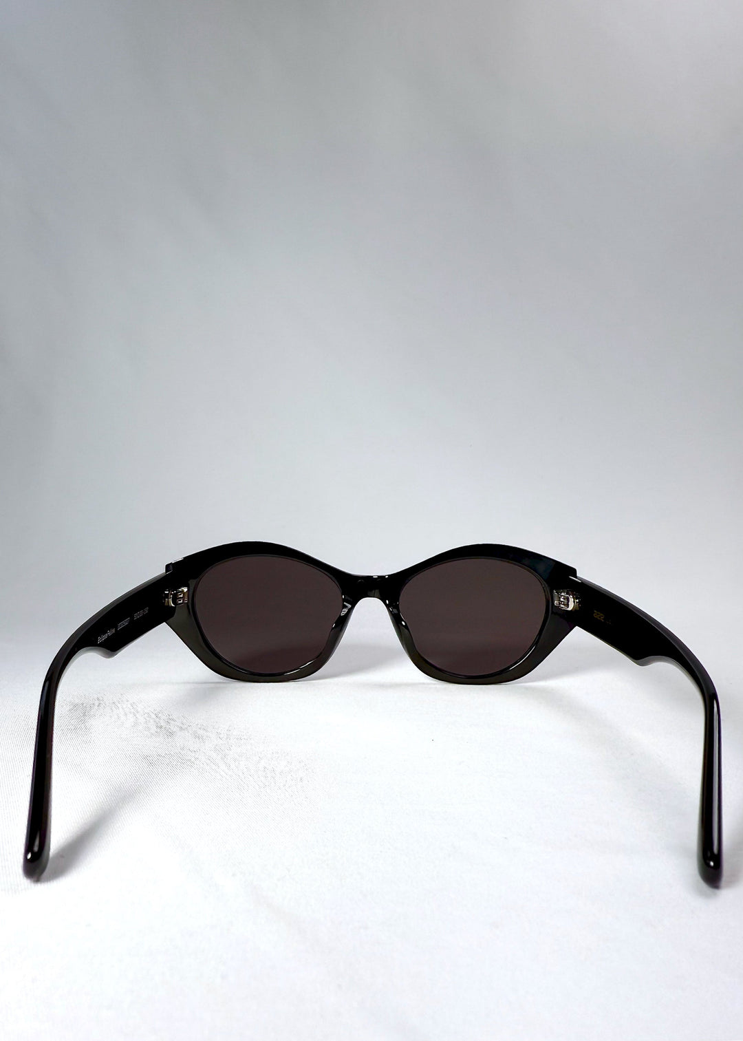 Back view of Eclipse Feline sunglasses showing the frame curvature and fixed-fit temples. 
