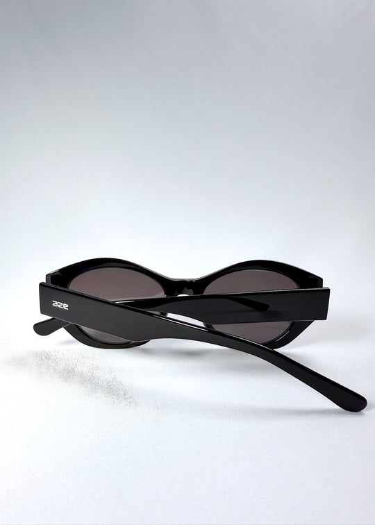 Folded view of Eclipse Feline - Obsidian Black with visible temple detail and compact design. 