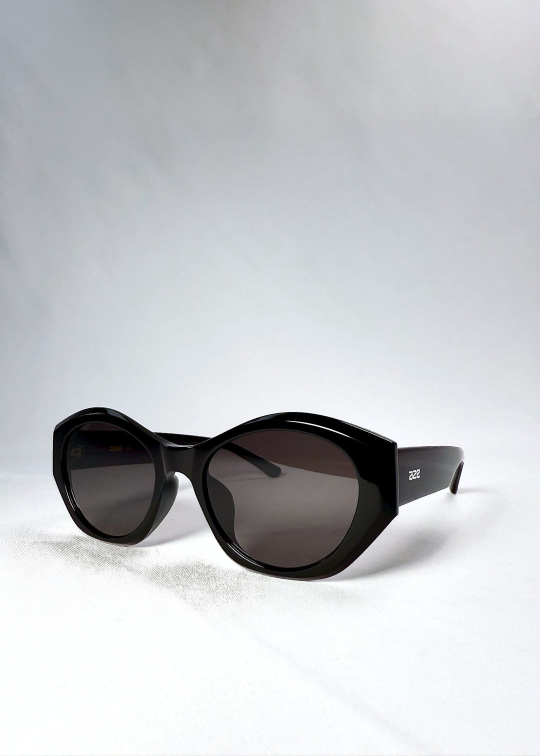 Angled front view of Eclipse Feline - Obsidian Black sunglasses showcasing the bold browline and HD nylon lenses. 