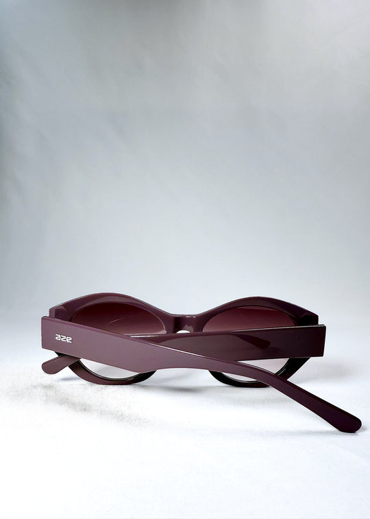 Folded view of Eclipse Feline - Twilight Plum sunglasses, displaying the compact profile and frame silhouette. 