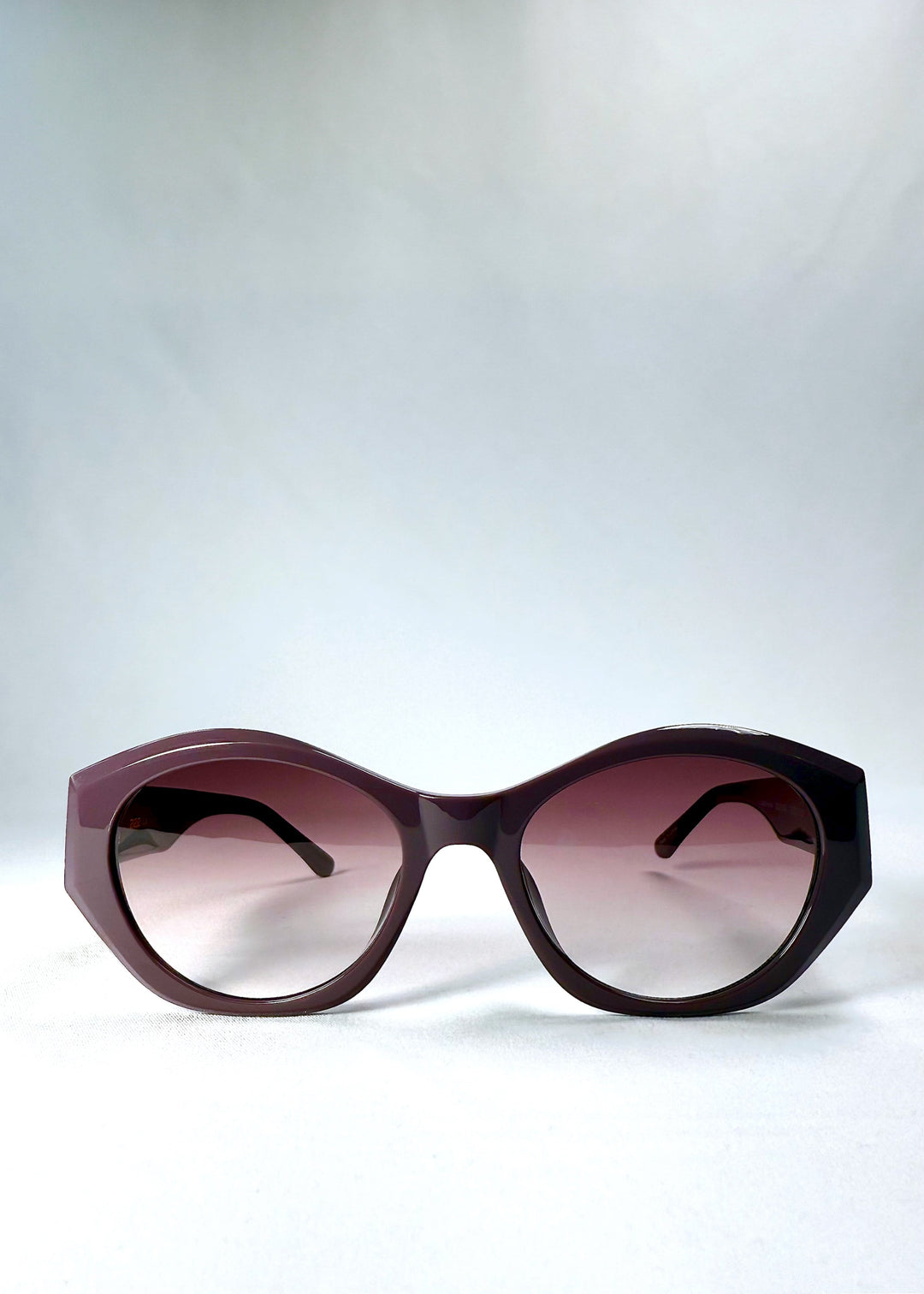 Front view of Eclipse Feline - Twilight Plum sunglasses, highlighting the bold cat-eye shape and gradient purple lenses. 