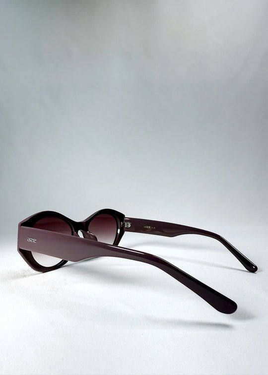 Side view of Eclipse Feline - Twilight Plum with wide sculpted temples and translucent plum finish.