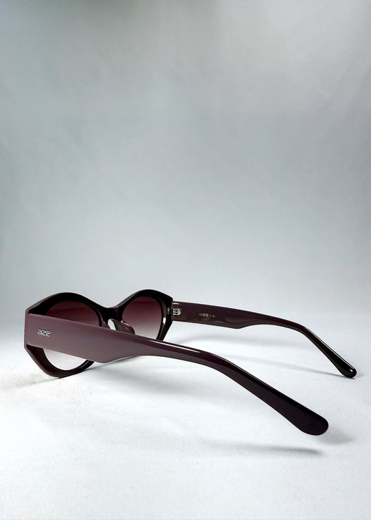 Side view of Eclipse Feline - Twilight Plum with wide sculpted temples and translucent plum finish. 