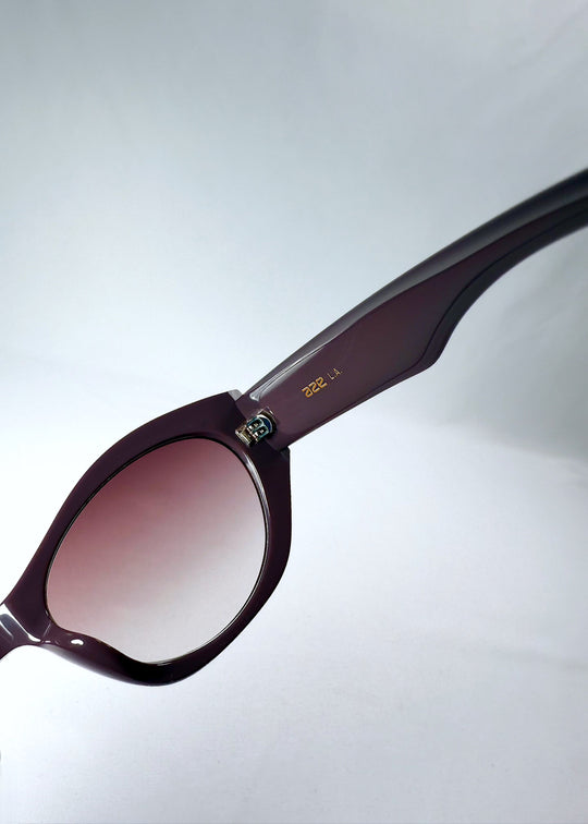 Closeup of Eclipse Feline - Twilight Plum temple, highlighting the subtle Aze logo and glossy acetate finish.