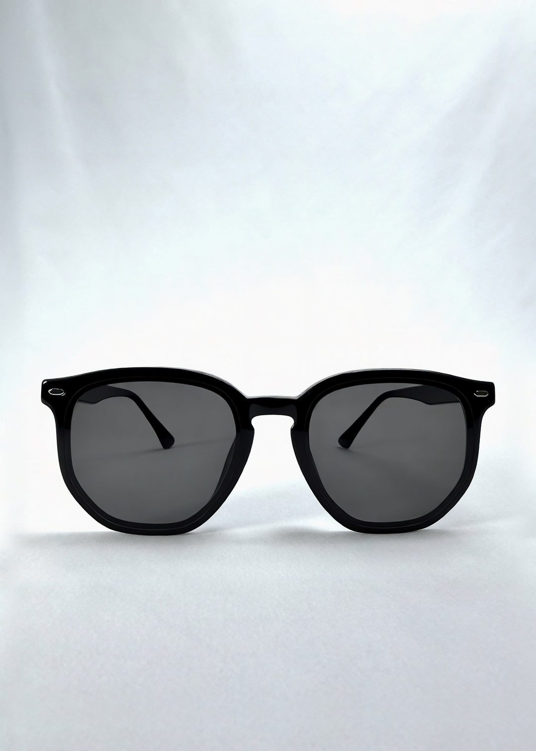 Front view of Elara sunglasses in Obsidian Black, featuring black acetate frame and dark lenses, showing the full front silhouette.
