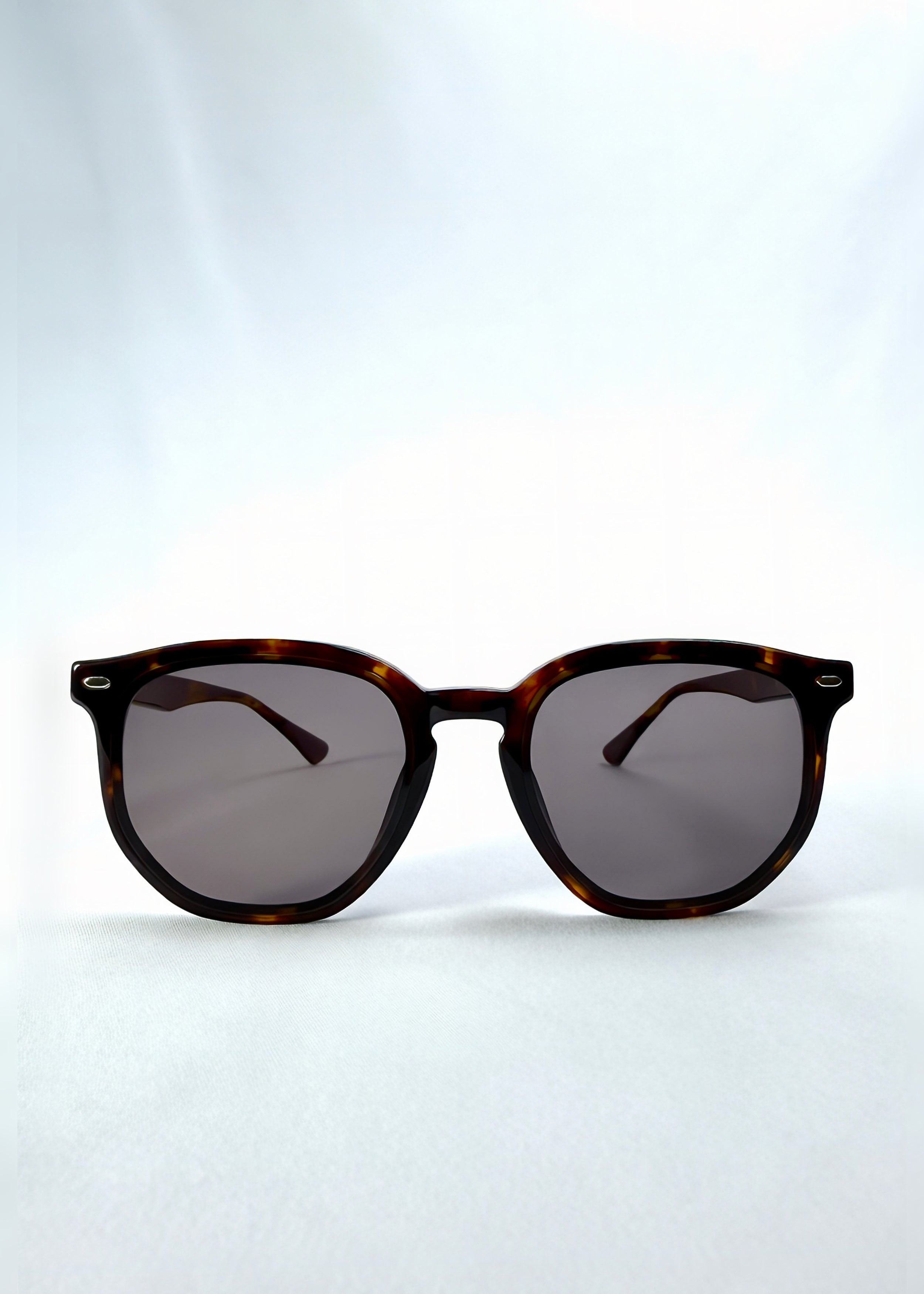 Front view of Elara sunglasses in Tortoiseshell, featuring tortoiseshell acetate frame and dark lenses, showing the full front silhouette.