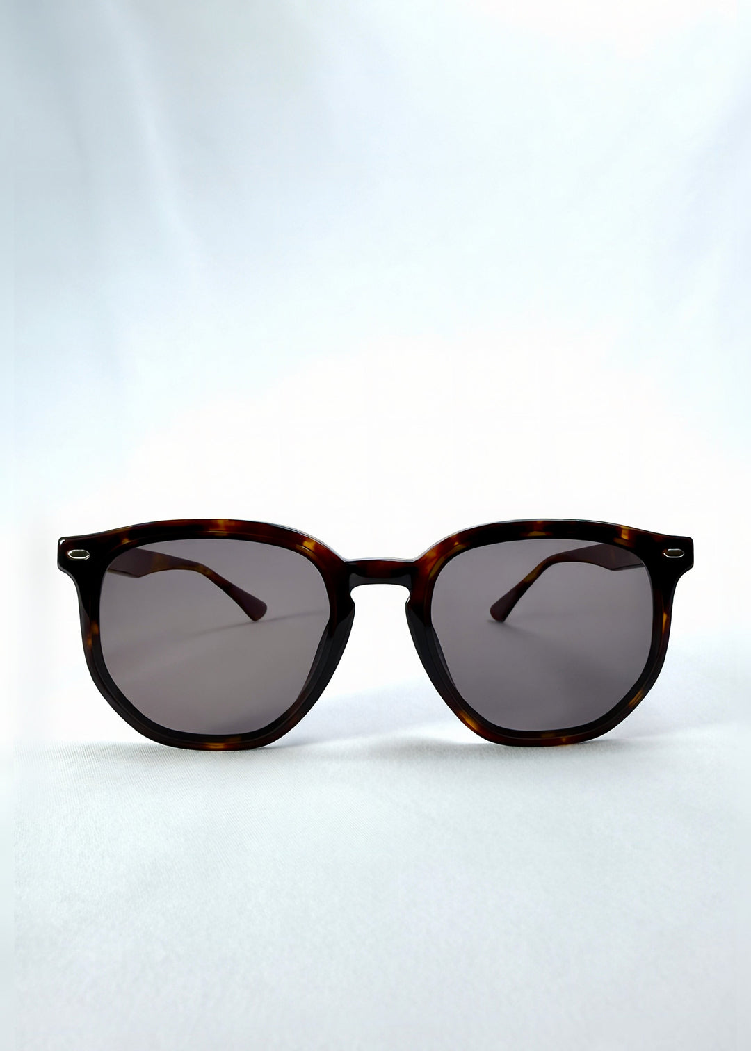 Front view of Elara sunglasses in Tortoiseshell, featuring tortoiseshell acetate frame and dark lenses, showing the full front silhouette. 