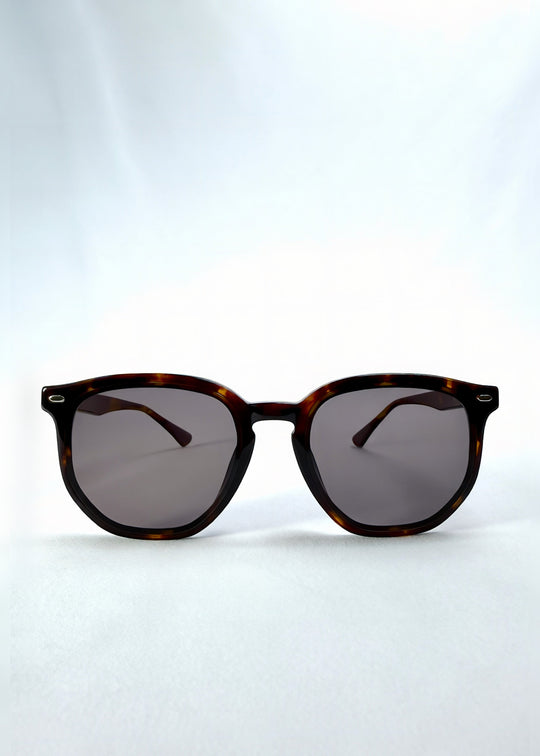 Front view of Elara sunglasses in Tortoiseshell, featuring tortoiseshell acetate frame and dark lenses, showing the full front silhouette. 