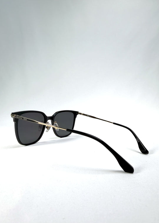 Back-angle view of Eon Drift sunglasses in Duskgold, featuring a structured black frame, gold-tone accents, and smoky lenses, showing the rear frame structure and temple alignment.