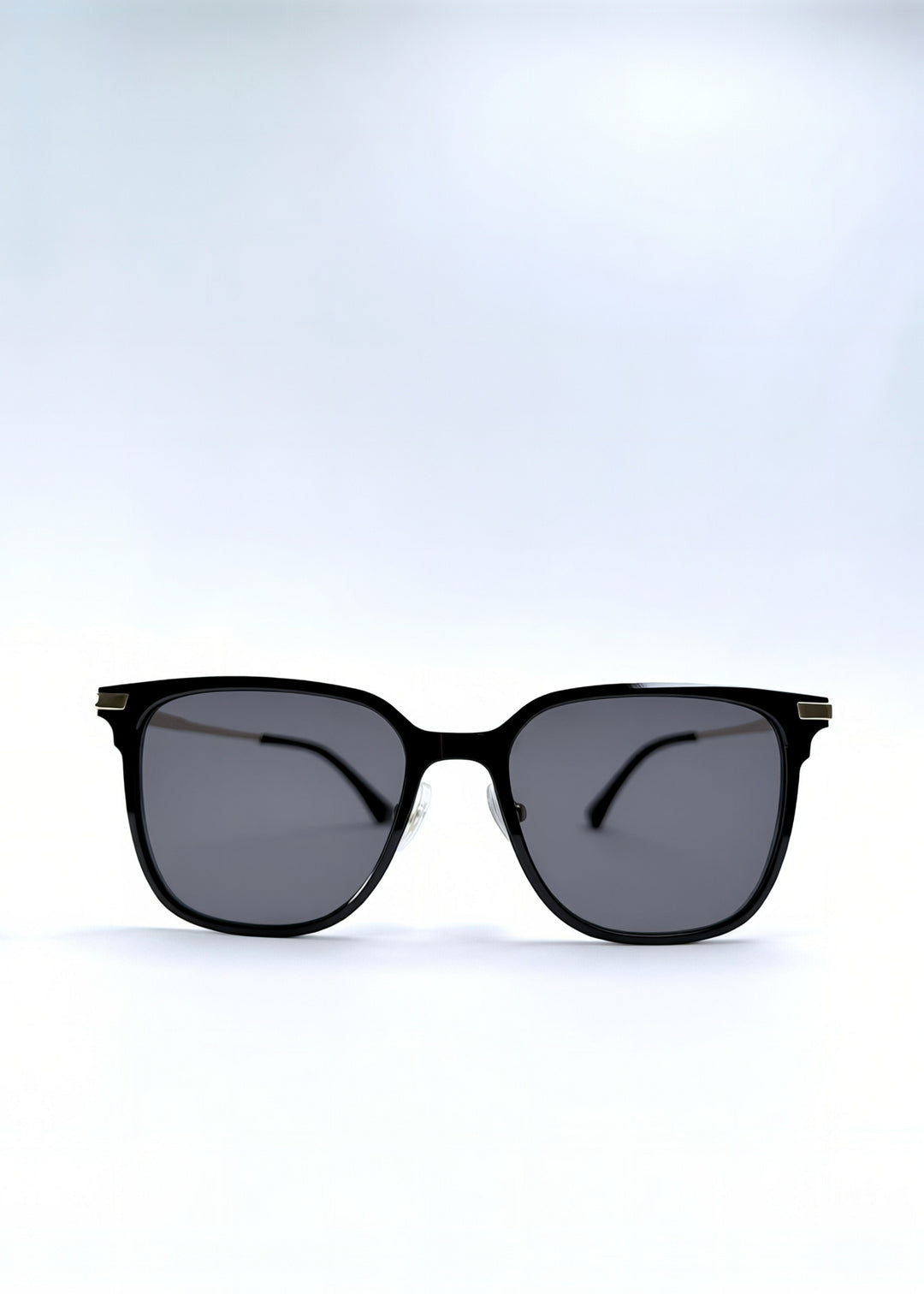Front view of Eon Drift sunglasses in Duskgold, featuring a structured black frame, gold-tone accents, and smoky lenses, showing the full front silhouette.