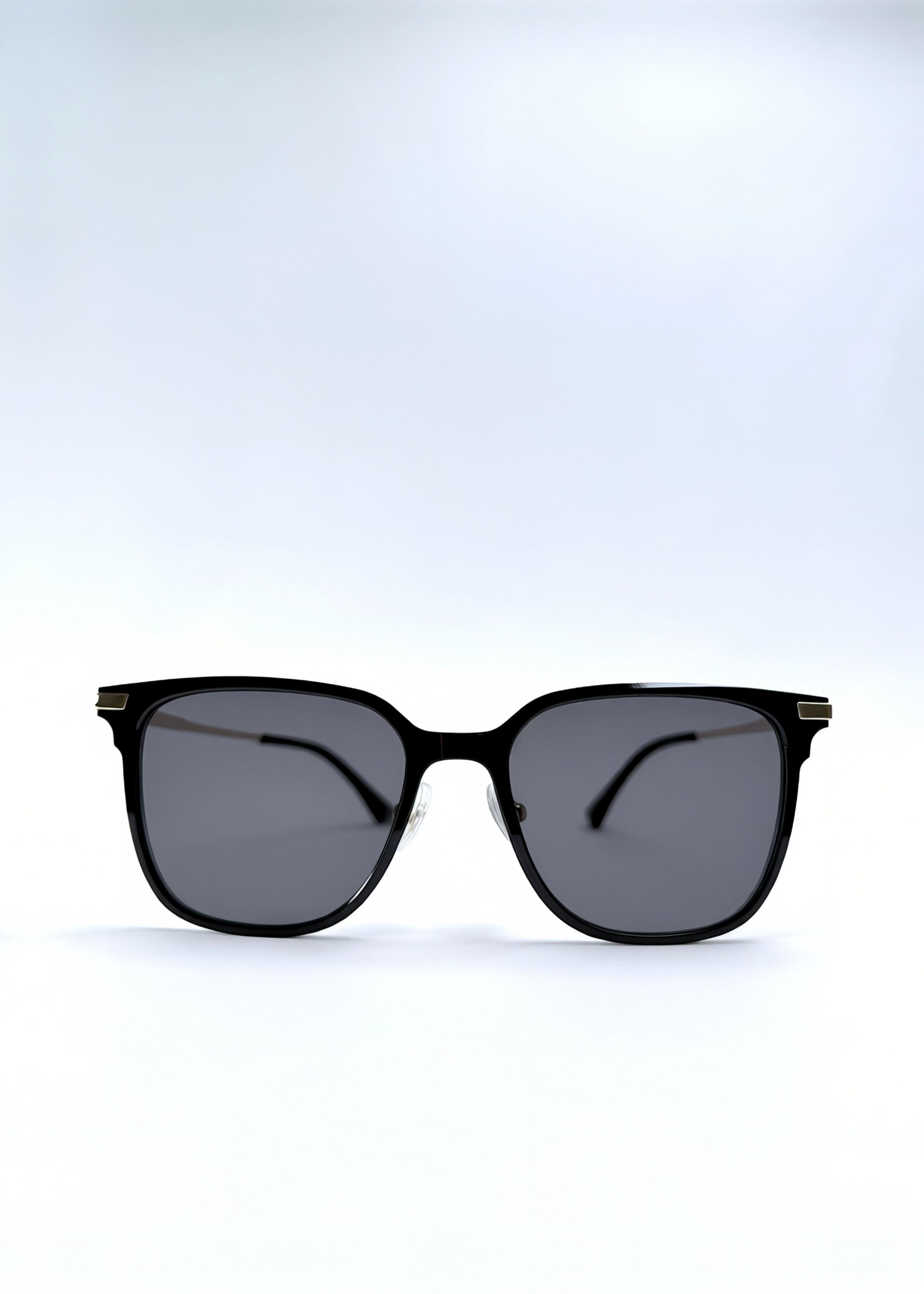 Front view of Eon Drift sunglasses in Duskgold, featuring a structured black frame, gold-tone accents, and smoky lenses, showing the full front silhouette.