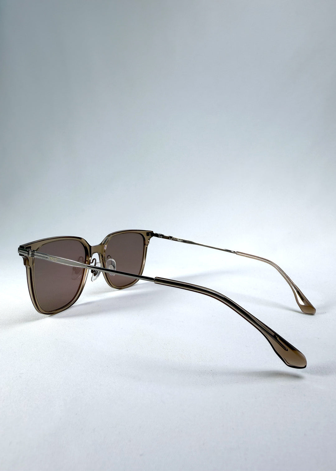 Back-angle view of Eon Drift sunglasses in Mocha Bronze, featuring a warm mocha frame, bronze-tone accents, and brown gradient lenses, showing the rear frame structure and temple alignment.