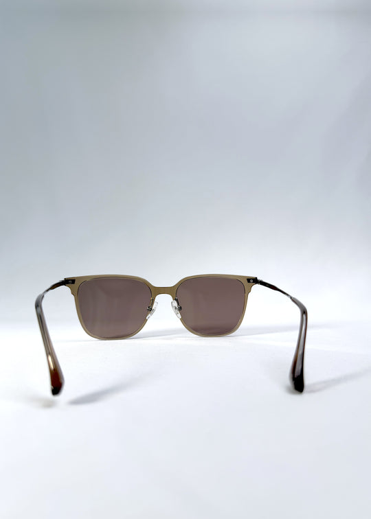 Back view of Eon Drift sunglasses in Mocha Bronze, featuring a warm mocha frame, bronze-tone accents, and brown gradient lenses, showing the inside frame and open temples.