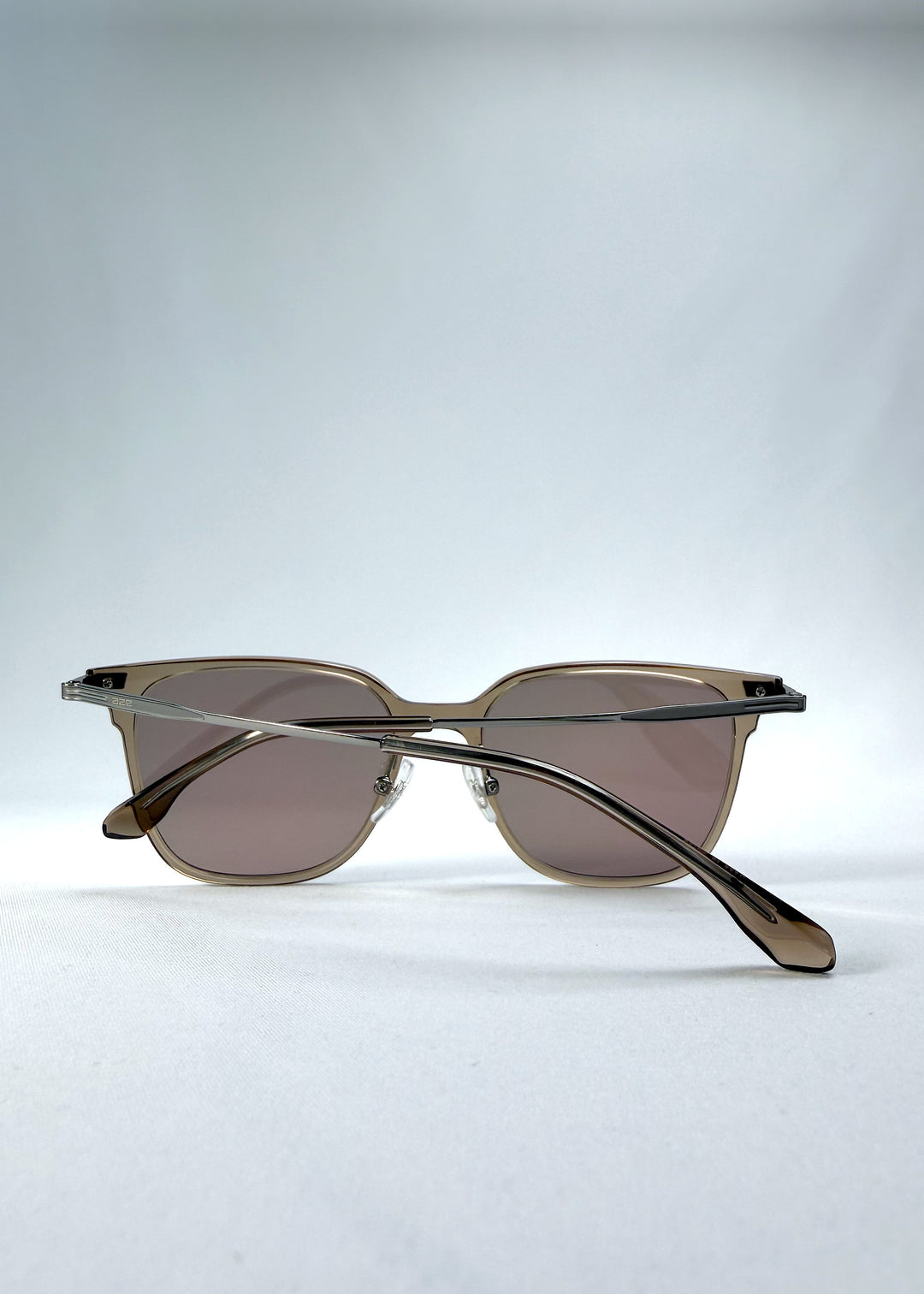 Folded view of Eon Drift sunglasses in Mocha Bronze, featuring a warm mocha frame, bronze-tone accents, and brown gradient lenses, showing the folded temples and frame profile.