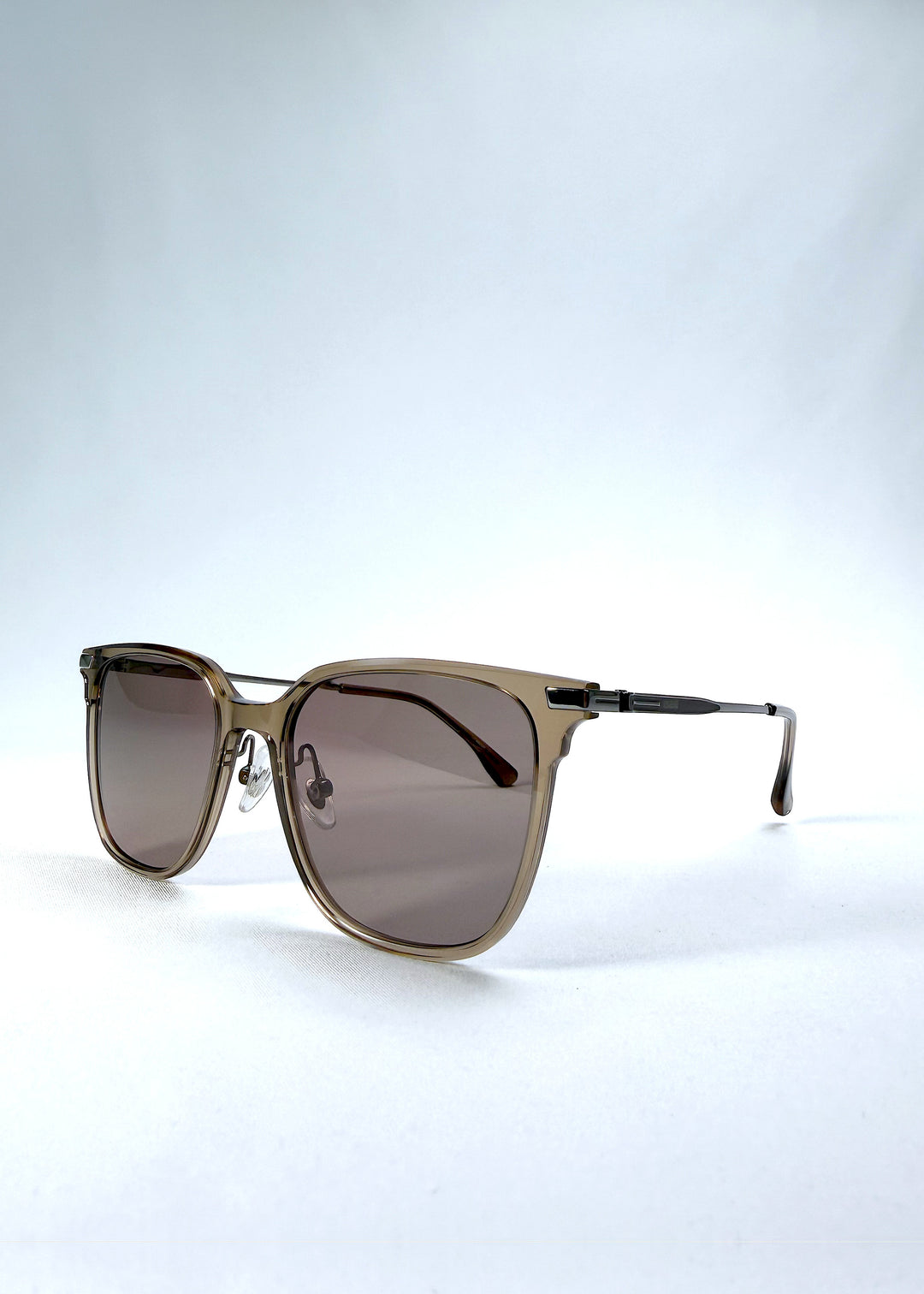 Three-quarter front view of Eon Drift sunglasses in Mocha Bronze, featuring a warm mocha frame, bronze-tone accents, and brown gradient lenses, showing the frame shape and temple profile.