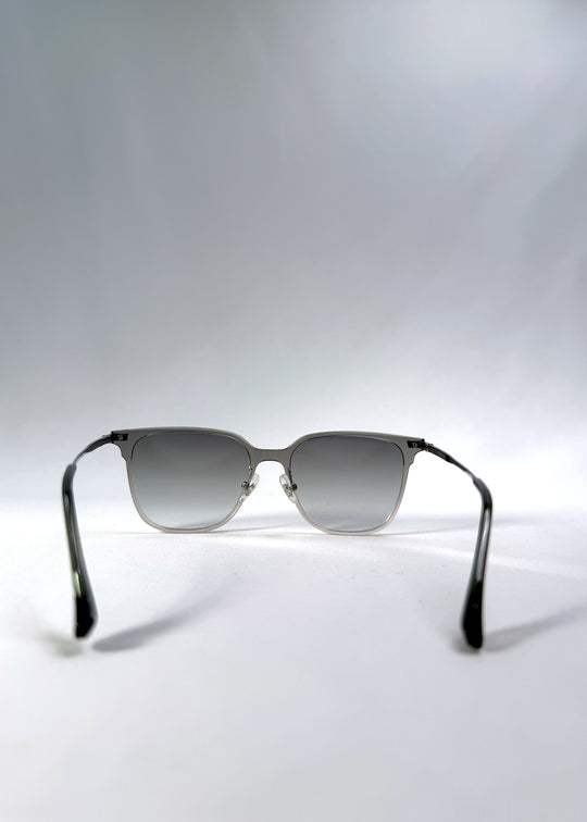Back view of Eon Drift sunglasses in Olive Shadow, featuring a translucent olive-gray frame and gray gradient lenses, showing the inside frame and open temples.