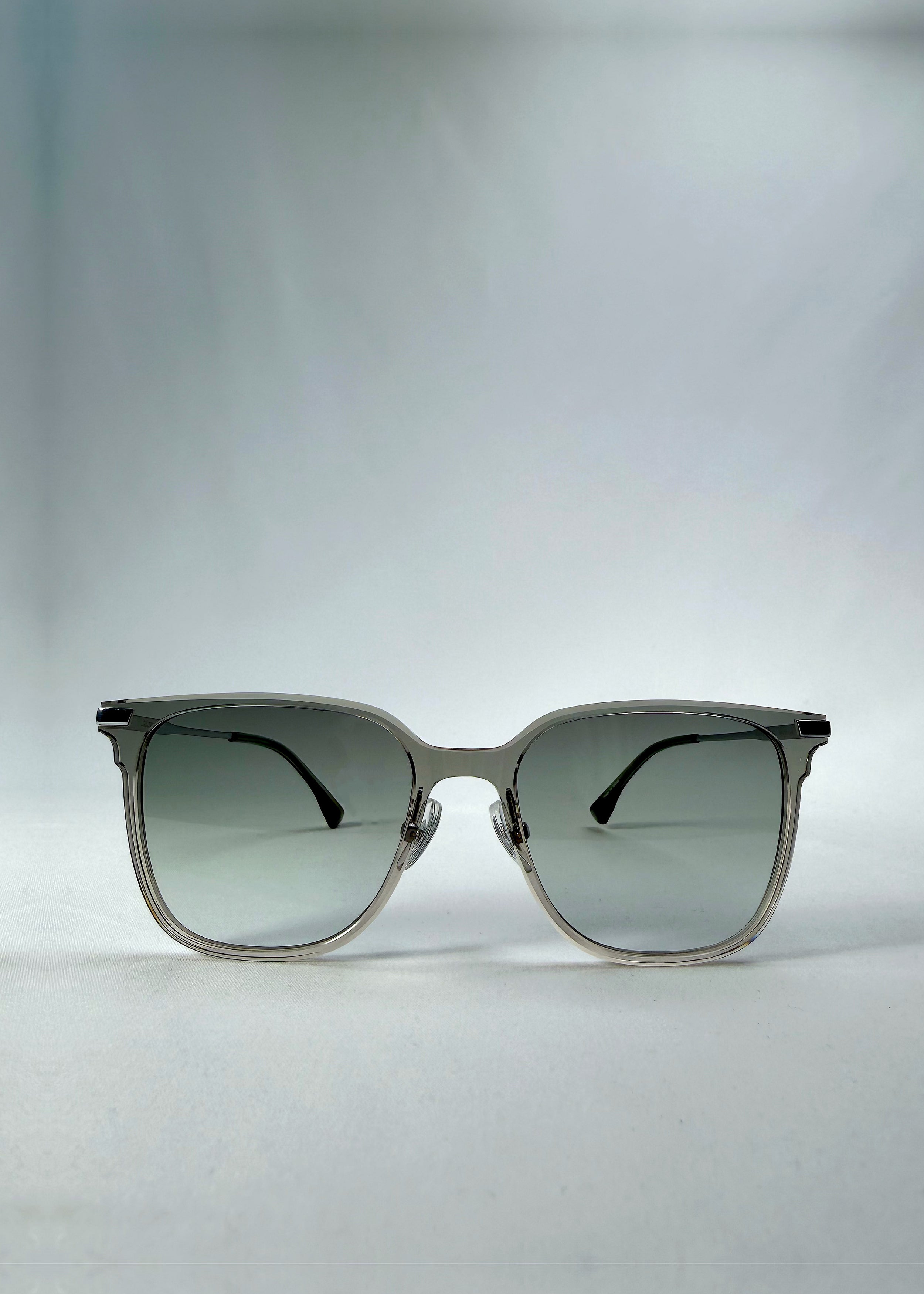Front view of Eon Drift sunglasses in Olive Shadow, featuring a translucent olive-gray frame and gray gradient lenses, showing the full front silhouette.
