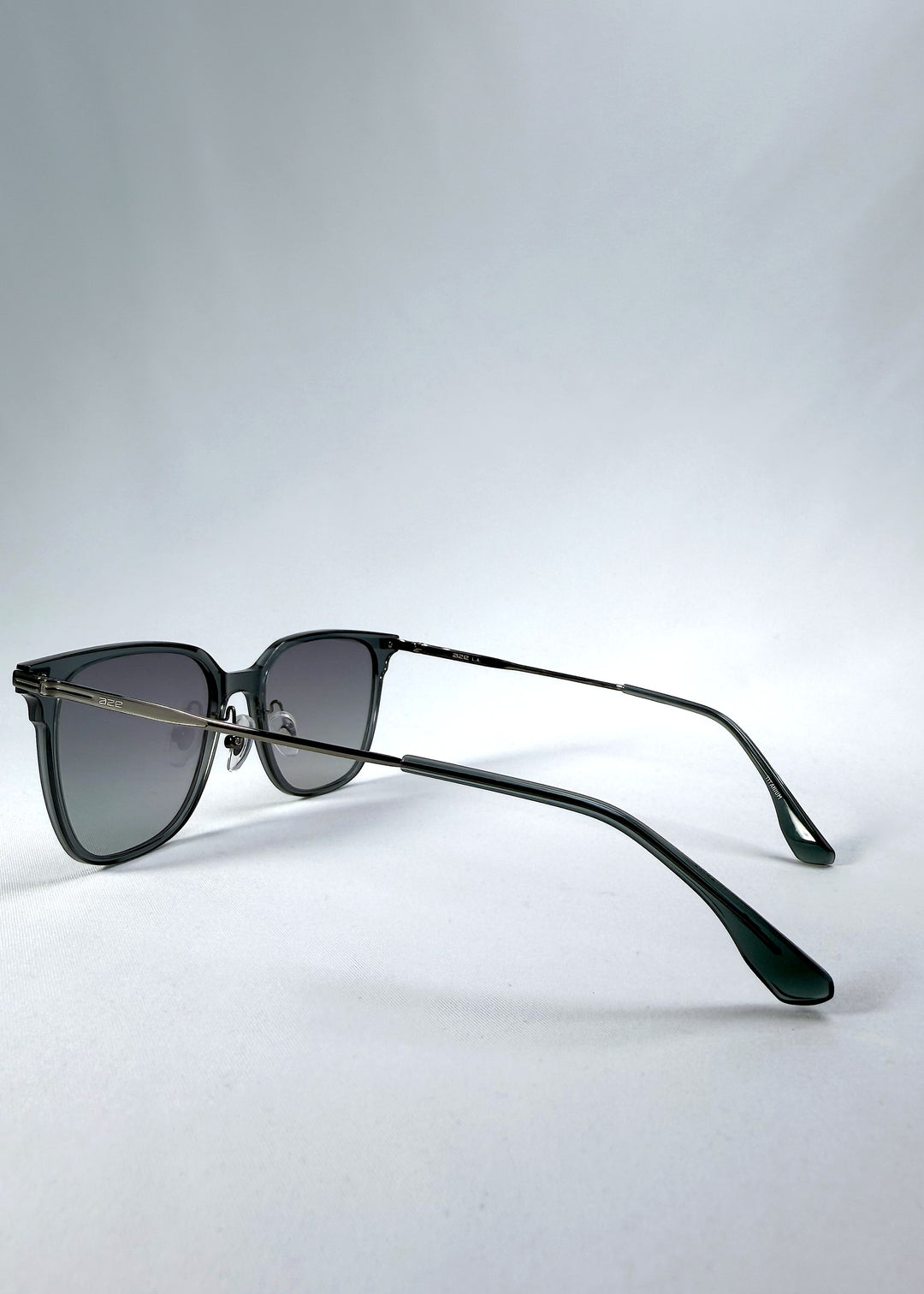 Back-angle view of Eon Drift sunglasses in Onyx Fade, featuring a dark onyx frame and gray gradient lenses, showing the rear frame structure and temple alignment.