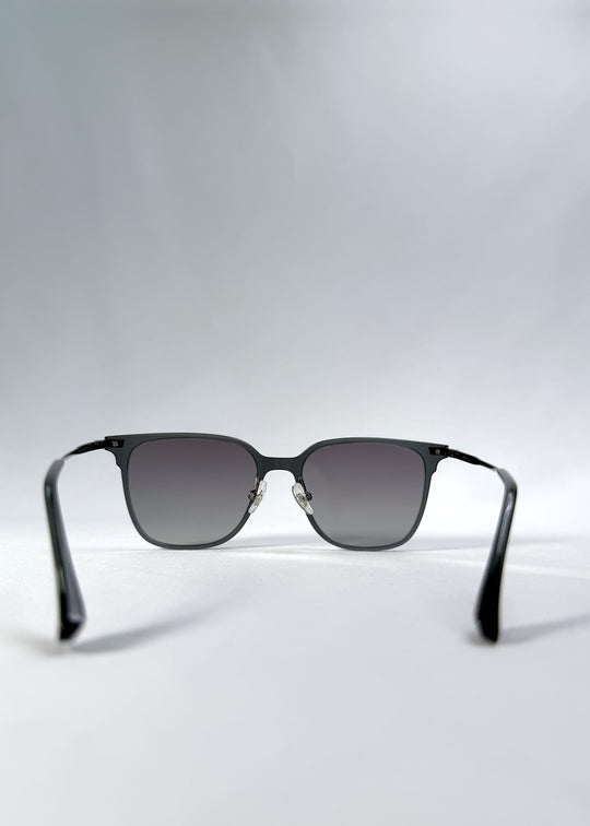 Back view of Eon Drift sunglasses in Onyx Fade, featuring a dark onyx frame and gray gradient lenses, showing the inside frame and open temples.