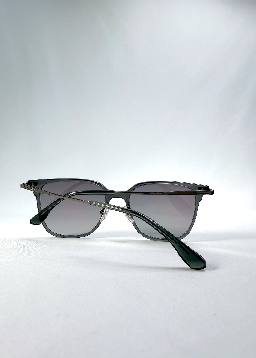 Folded view of Eon Drift sunglasses in Onyx Fade, featuring a dark onyx frame and gray gradient lenses, showing the folded temples and frame profile.