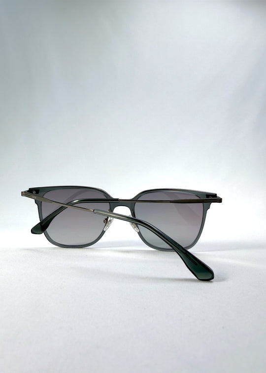 Folded view of Eon Drift sunglasses in Onyx Fade, featuring a dark onyx frame and gray gradient lenses, showing the folded temples and frame profile.