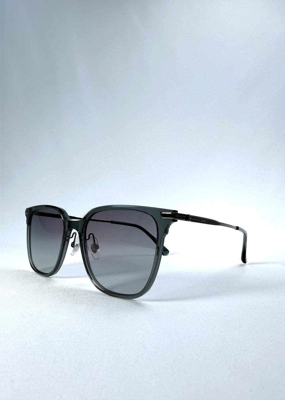 Three-quarter front view of Eon Drift sunglasses in Onyx Fade, featuring a dark onyx frame and gray gradient lenses, showing the frame shape and temple profile.